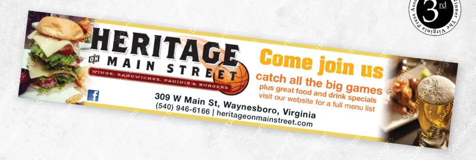 A 3rd Place Virginia Press Association award-winning horizontal strip advertisement for Heritage on Main Street in Waynesboro, VA, featuring a basketball theme, photos of a gourmet burger and a beer, and an invitation to watch big games.